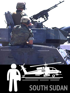 soldiers in an armored vehicle with weapon pointed at the sky